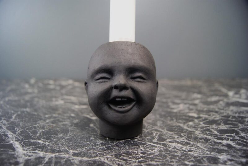SML BABY HEAD CH WITH TEETH BLK