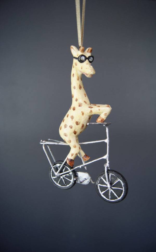 Geoffrey iraffe riding bike