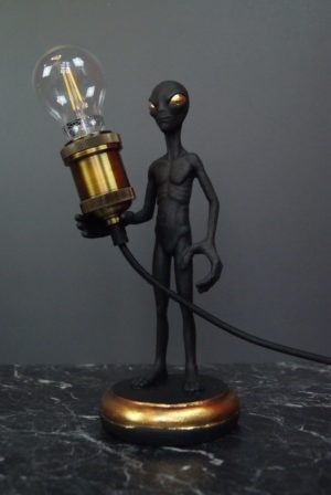 Alien holding black w/ gold eyes