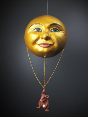 Mouse holding on chain in gold moonface