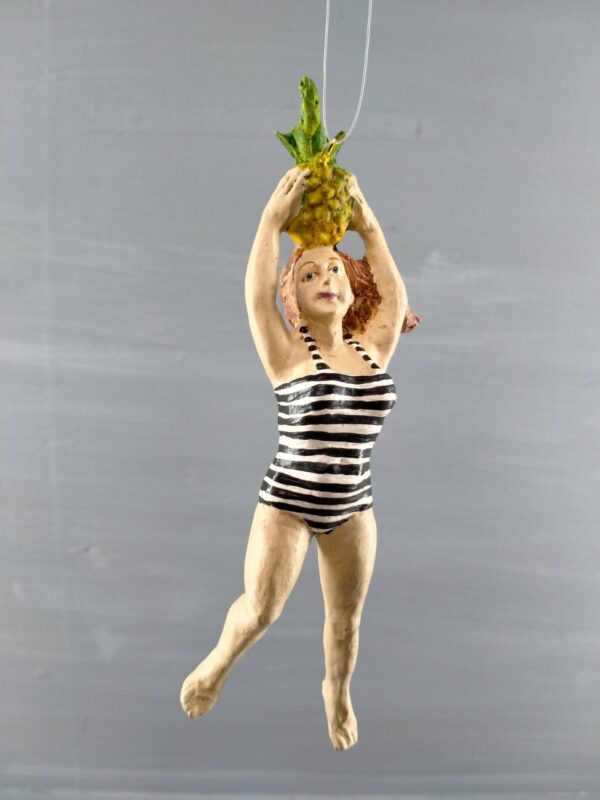 Beach lady holding pineapple in blk/white stripes swimsuit