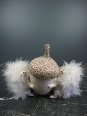 Squirel in pearlwhite hugging white acorn cup w/ feather tail