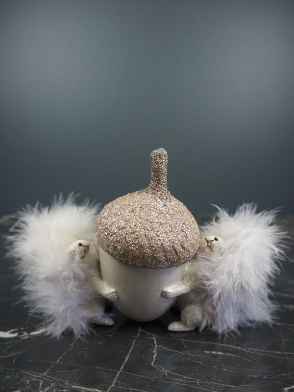 Squirel in pearlwhite hugging white acorn cup w/ feather tail