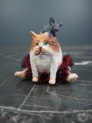 Mouse riding on fat cat with red fabskirt