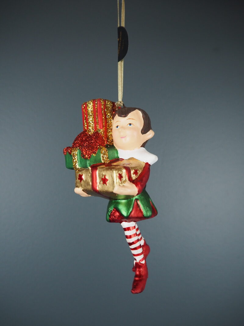 Long legged elf with big gold gift orn